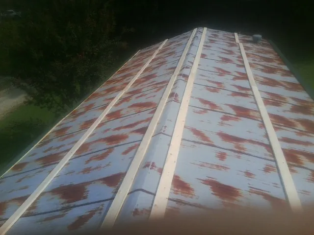 Rusted metal roof panels with new wood purlins before replacement — Storm Damage Roof Repair in Dorr by Roofing Brothers